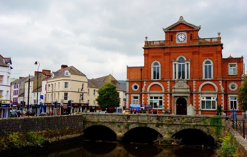 A red brick building with a clock on top.